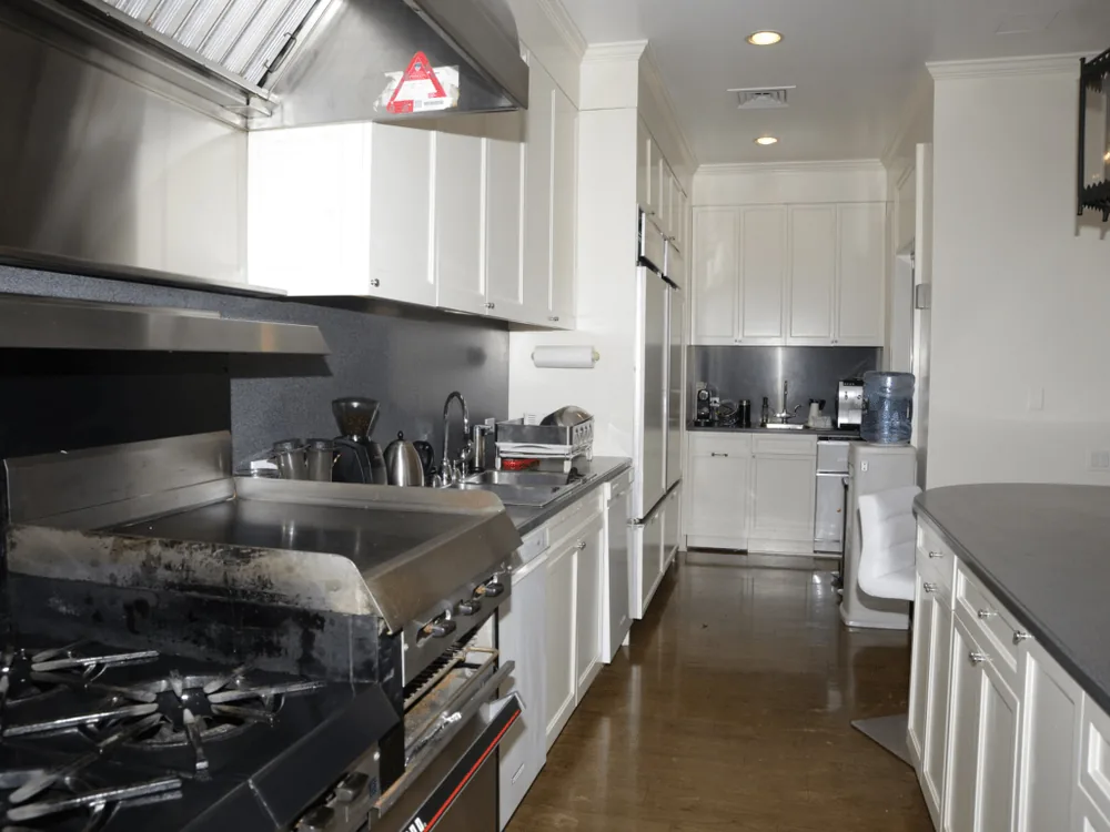 A modern kitchen with white cabinets and stainless-steel appliances